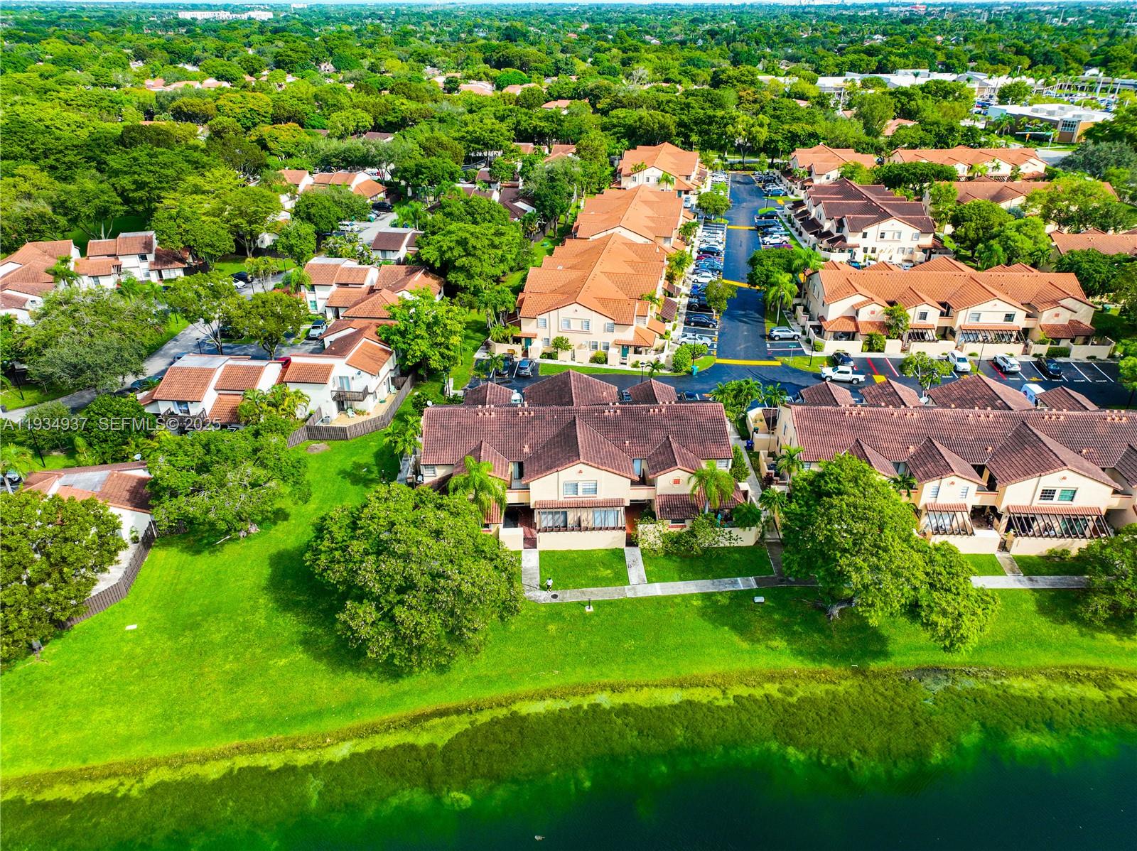 13292 Southwest 114th Terrace Miami, FL 33186 - Photo 61 of 65 an aerial view of residential houses with outdoor space and a lake view