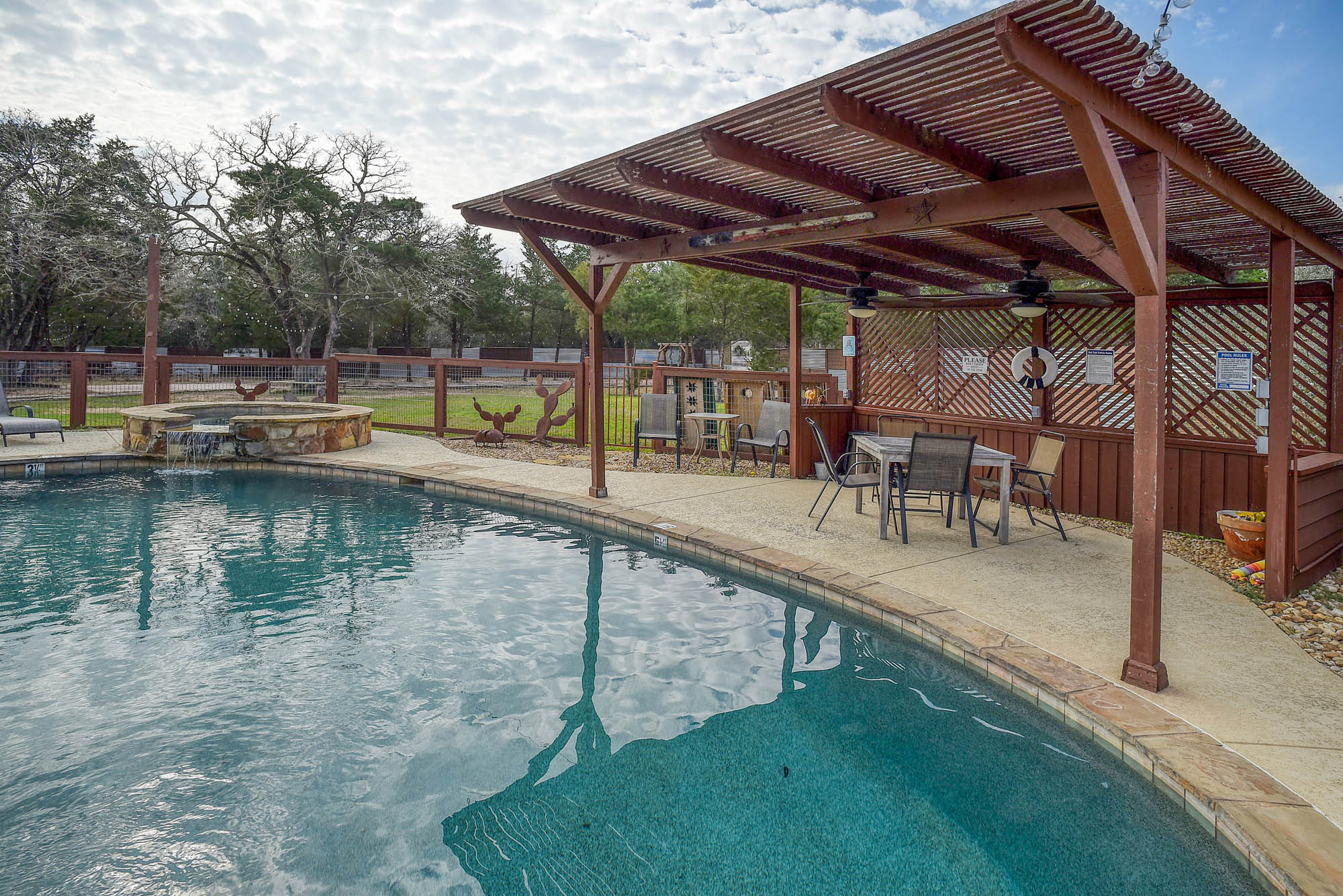 418 Vyvjala Road Smithville, TX 78957 - Photo 34 of 40 View of pool with a fenced backyard, a patio area, a pergola, outdoor dining space, and a pool with connected hot tub