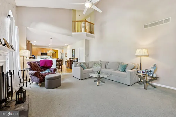 a living room with furniture and kitchen view