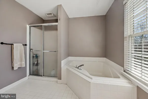 a bathroom with a bathtub and shower