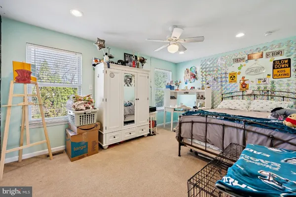 a bedroom with furniture and a large window