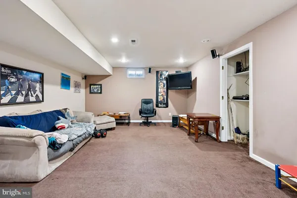a living room with furniture and a gym machine