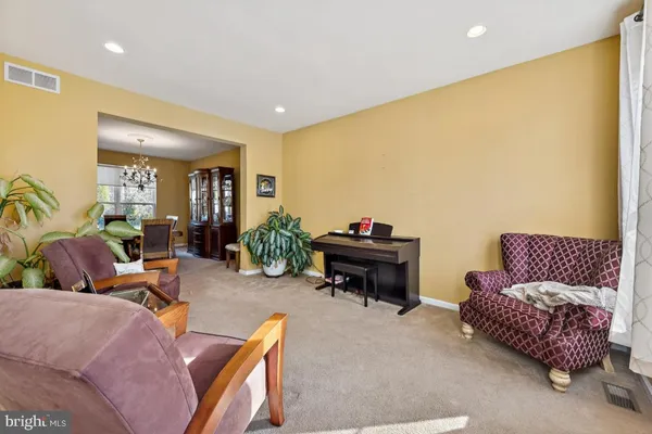 a living room with furniture and a piano