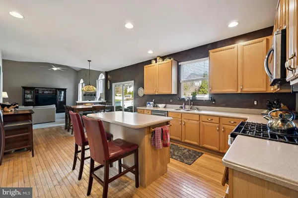 a kitchen with a table chairs sink and cabinets