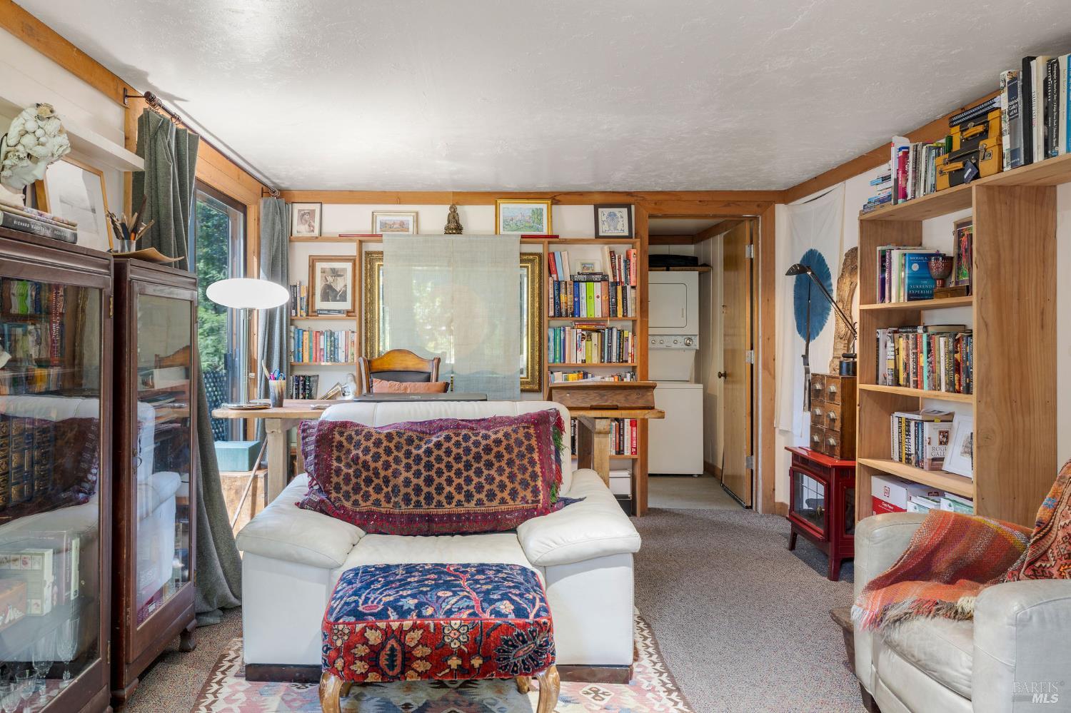 35570 Ocean View Street Gualala, CA 95445 - Photo 16 of 52 a living room with furniture and a book shelf