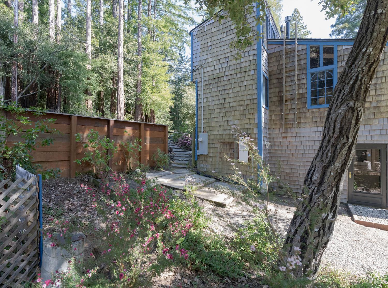 35570 Ocean View Street Gualala, CA 95445 - Photo 25 of 52 a backyard of a house with a tree