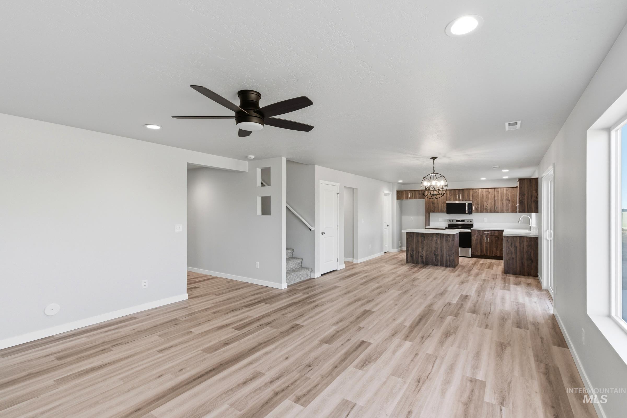 13709 Redway Court Caldwell, ID 83607 - Photo 10 of 28 Open-concept living area featuring wood-finish flooring, recessed lighting, and a contemporary ceiling fan