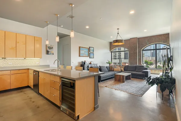 a kitchen with stainless steel appliances granite countertop a refrigerator and a sink