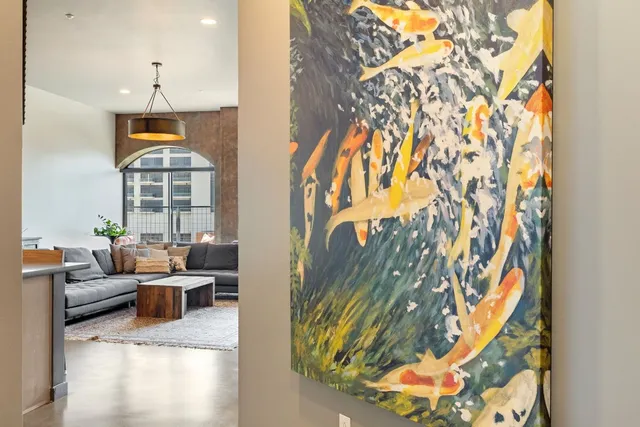 a kitchen with a faucet a chandelier and living room view