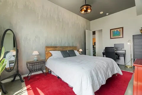 a bedroom with furniture and a window