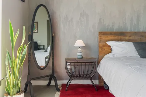 a living room with furniture a rug and a window