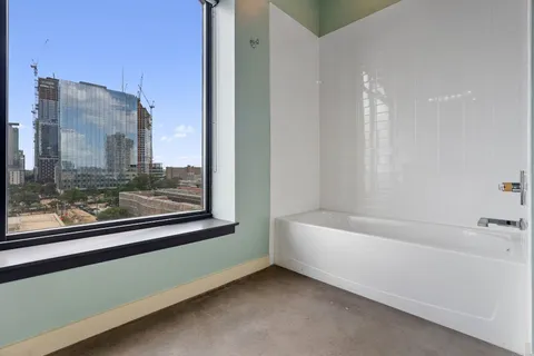 a bathroom with a bathtub and a shower