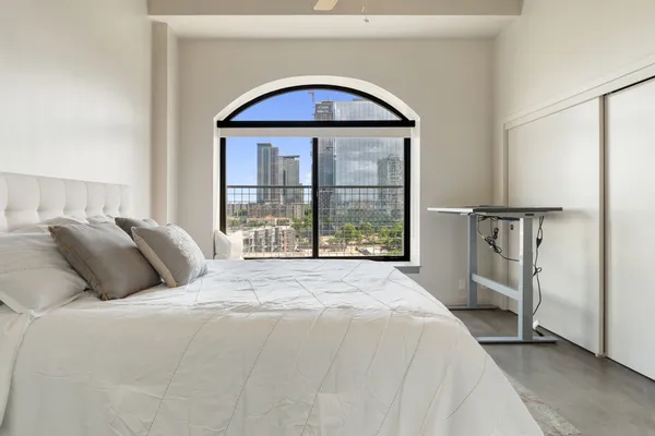 a bed sitting in a bedroom next to a window
