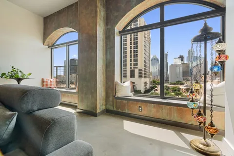 a view of a balcony with floor to ceiling windows with wooden floor