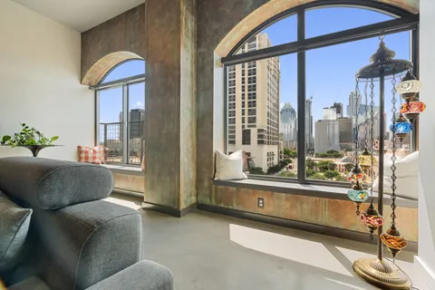 a view of a balcony with floor to ceiling windows with wooden floor