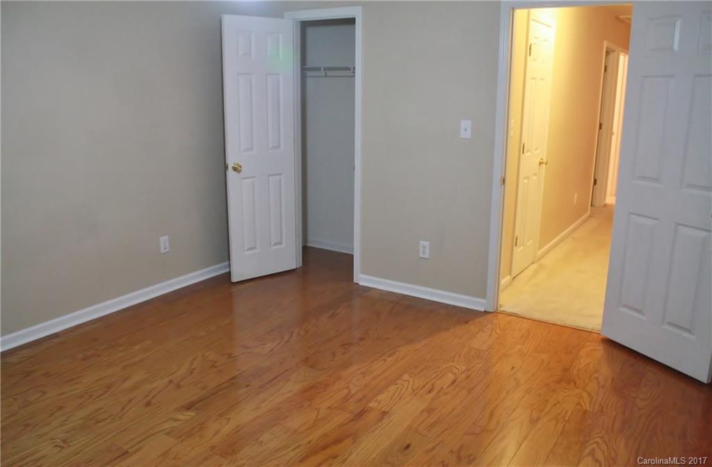7311 Henderson Park Road Huntersville, NC 28078 - Photo 14 of 23 an empty room with wooden floor and windows