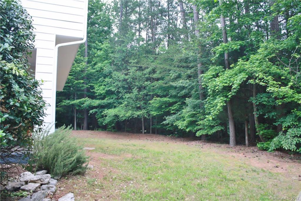 7311 Henderson Park Road Huntersville, NC 28078 - Photo 23 of 23 a view of a backyard with plants and large trees
