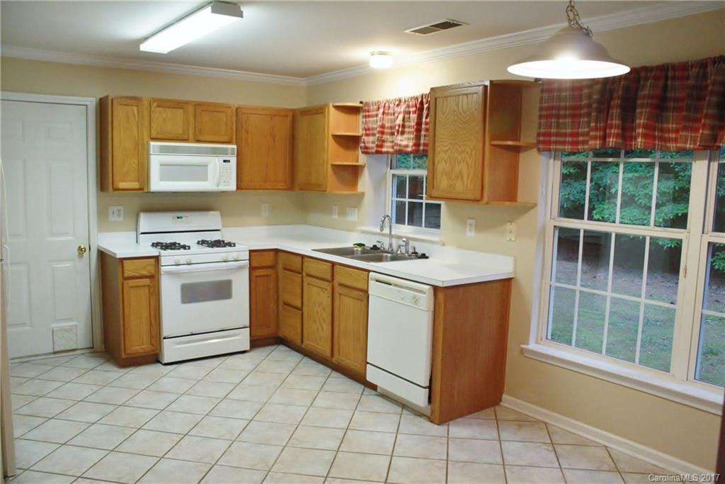 7311 Henderson Park Road Huntersville, NC 28078 - Photo 8 of 23 a kitchen with a stove a sink and a refrigerator