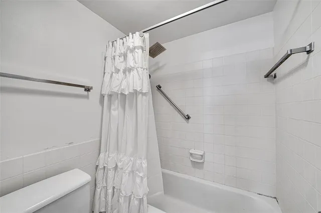 a bathroom with a shower and a toilet
