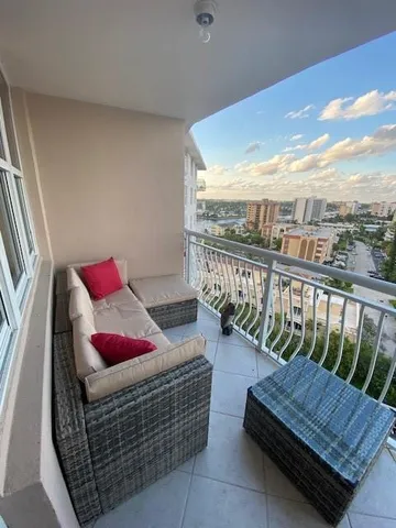 a balcony with furniture and a view of city