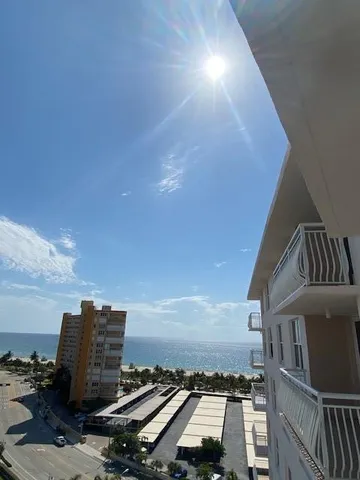 a view of roof deck with wooden floor and city view
