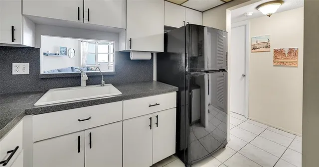 a kitchen with a refrigerator and a sink