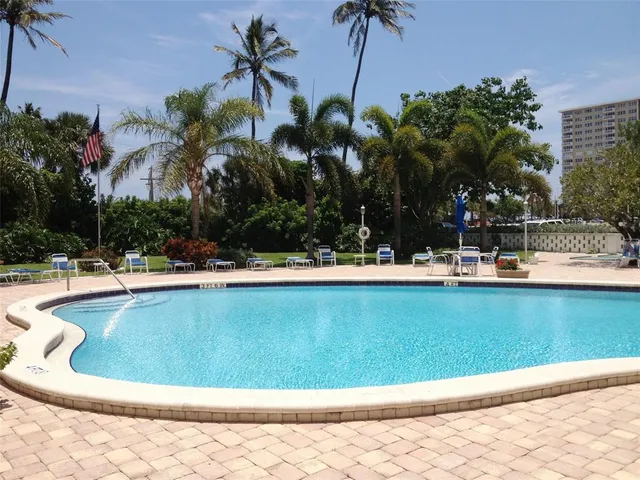 a view of a swimming pool with a table and chairs