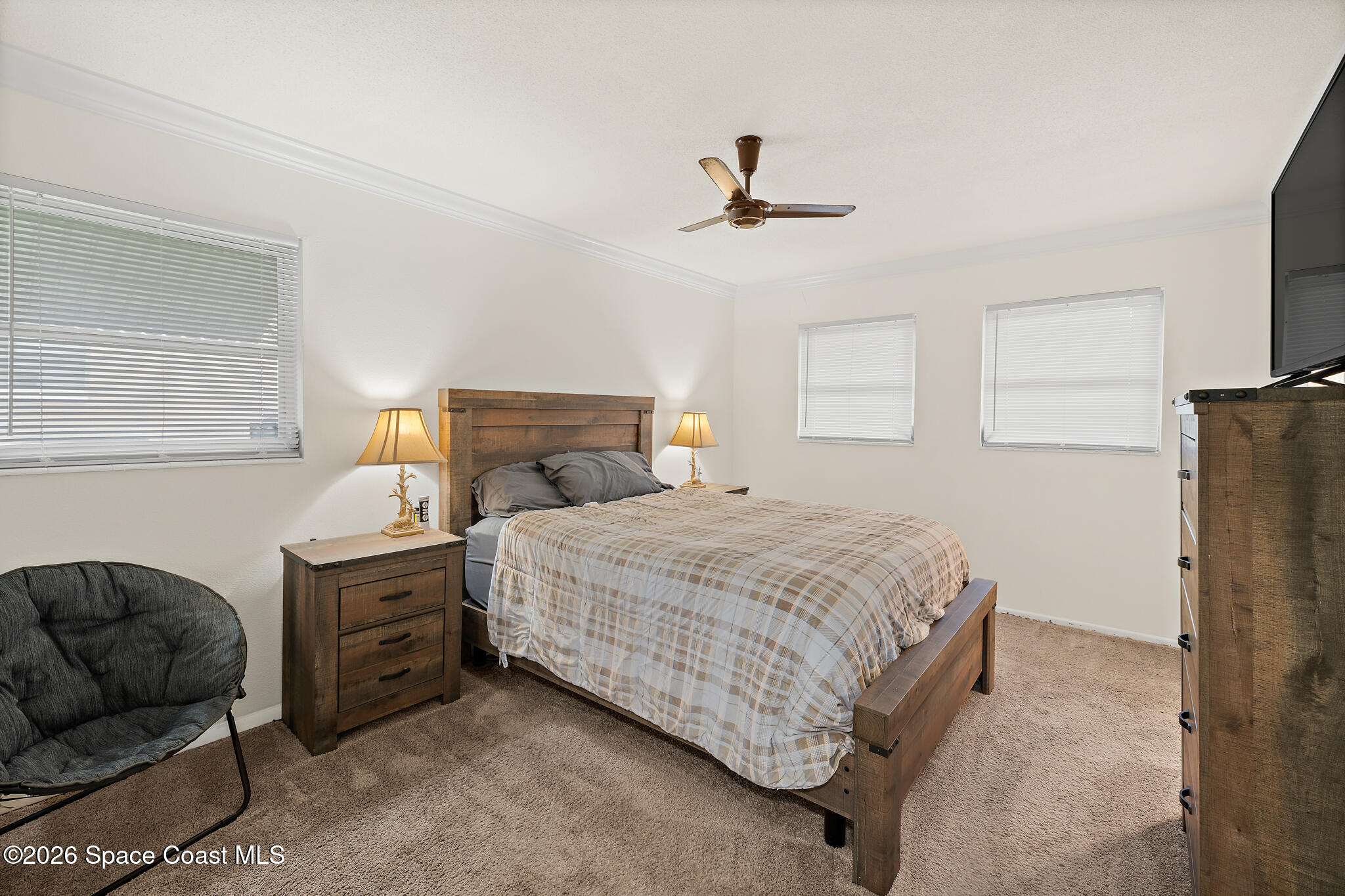 815 Glade Road Titusville, FL 32780 - Photo 12 of 30 a bedroom with a bed dresser and a window