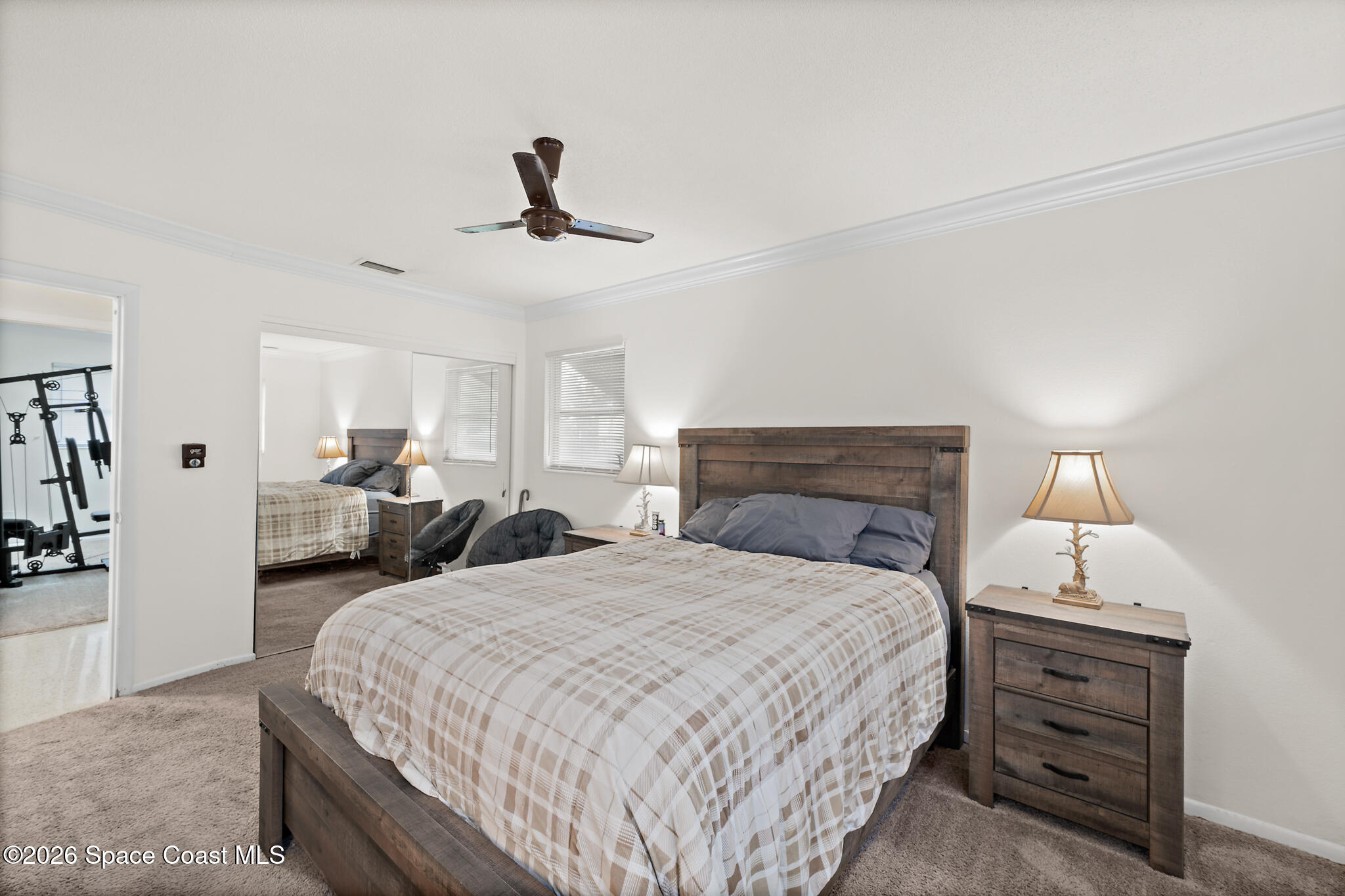 815 Glade Road Titusville, FL 32780 - Photo 13 of 30 a bedroom with a bed and ceiling fan