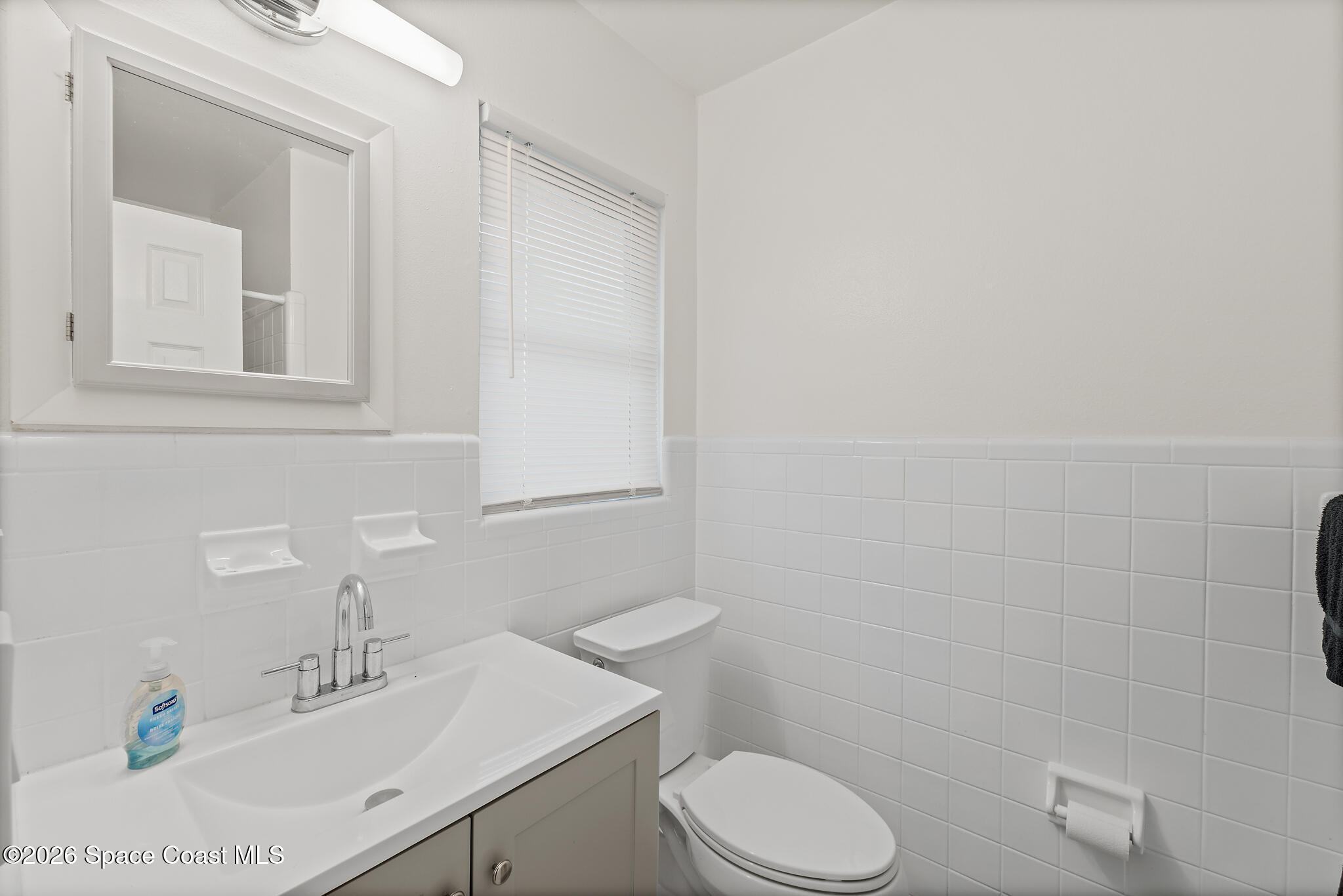 815 Glade Road Titusville, FL 32780 - Photo 14 of 30 a bathroom with a sink a toilet and mirror