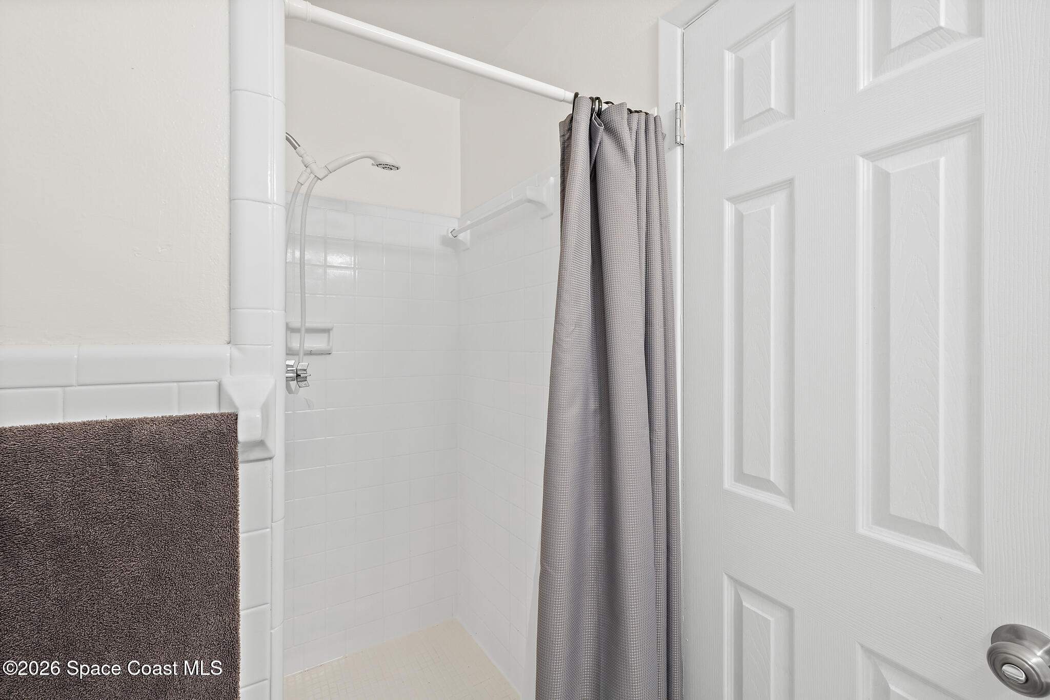 815 Glade Road Titusville, FL 32780 - Photo 15 of 30 a bathroom with a shower and a glass door