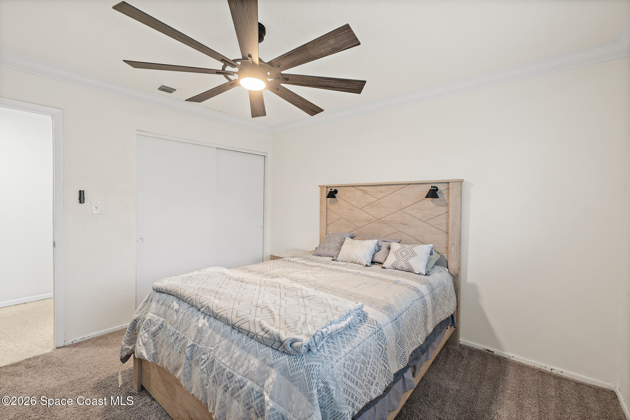 815 Glade Road Titusville, FL 32780 - Photo 17 of 30 a bedroom with a bed and a ceiling fan