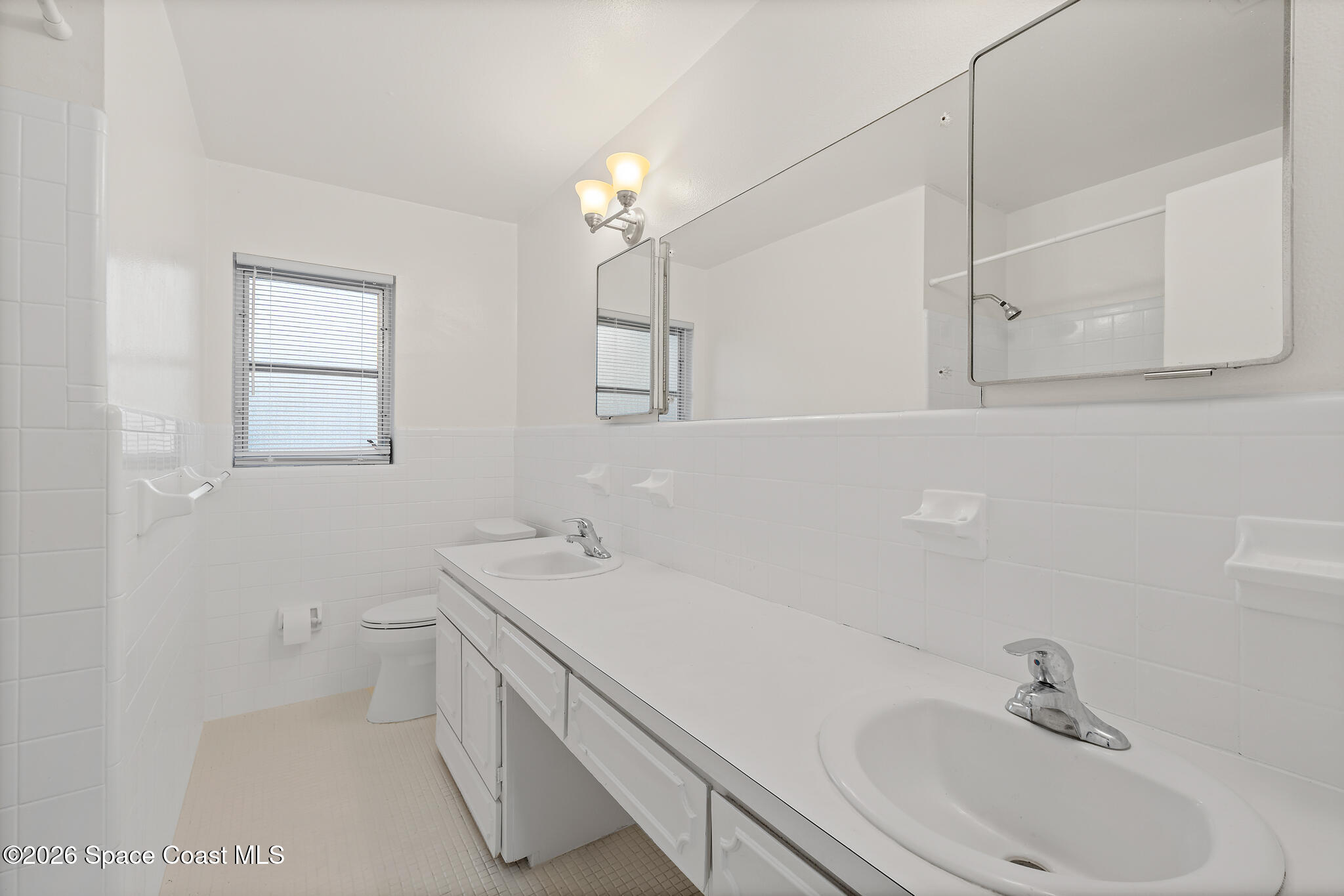 815 Glade Road Titusville, FL 32780 - Photo 18 of 30 a bathroom with a sink a vanity and mirror