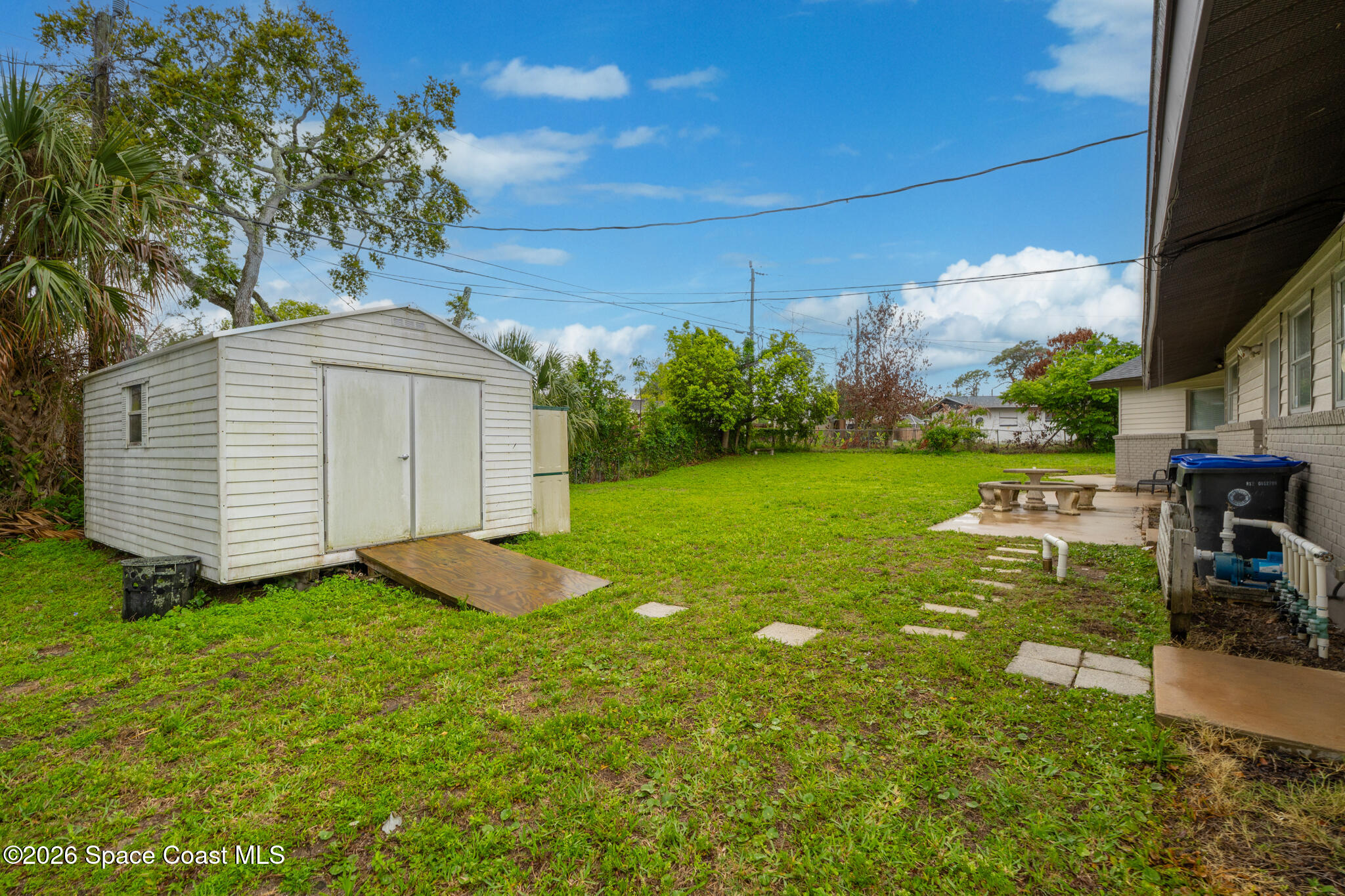 815 Glade Road Titusville, FL 32780 - Photo 27 of 30 a view of a backyard with plants and a patio