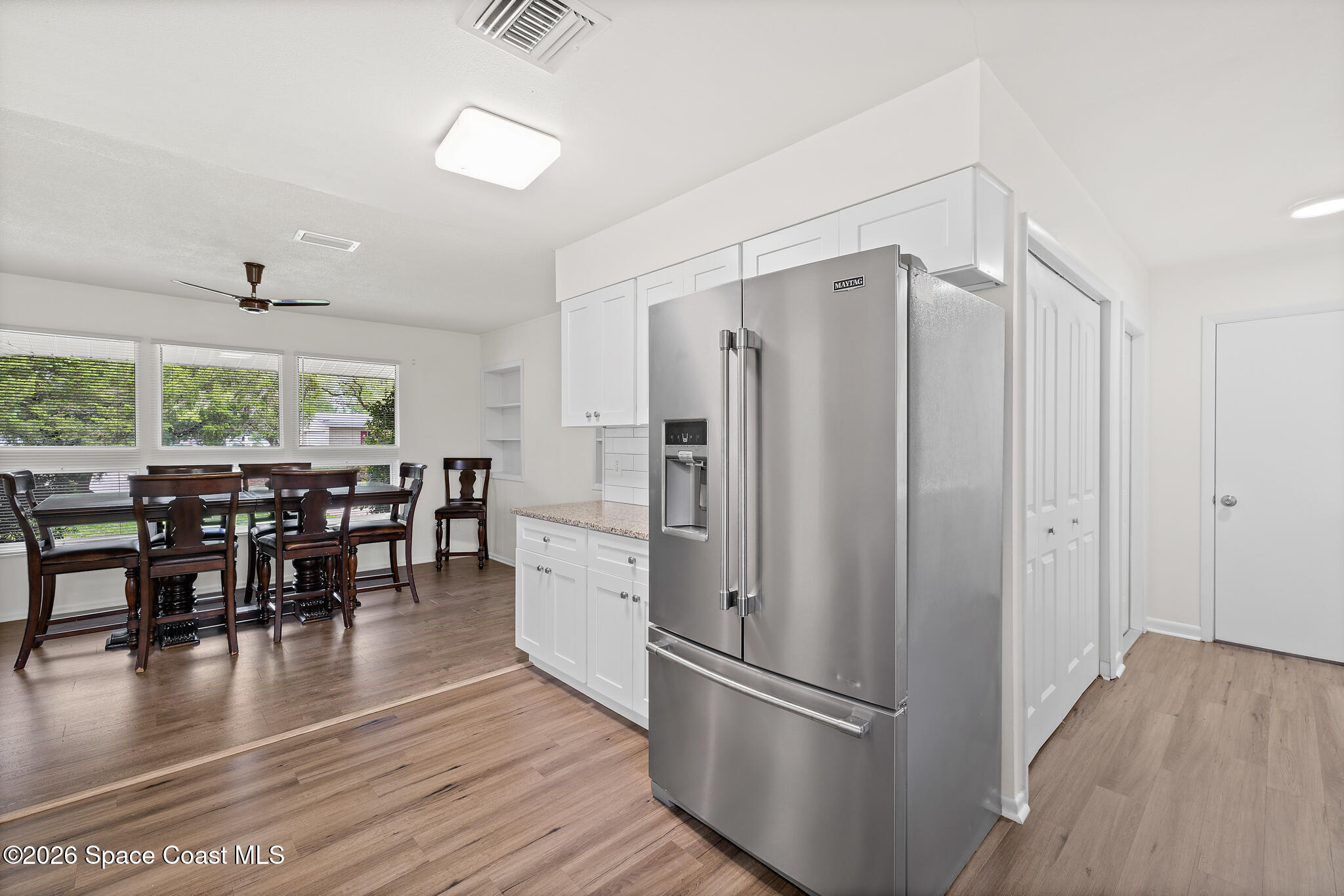 815 Glade Road Titusville, FL 32780 - Photo 5 of 30 a kitchen with stainless steel appliances granite countertop a refrigerator dining table and chairs