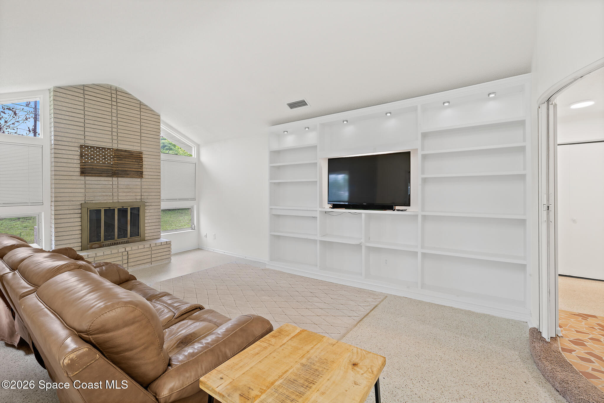 815 Glade Road Titusville, FL 32780 - Photo 10 of 30 a living room with furniture and a flat screen tv