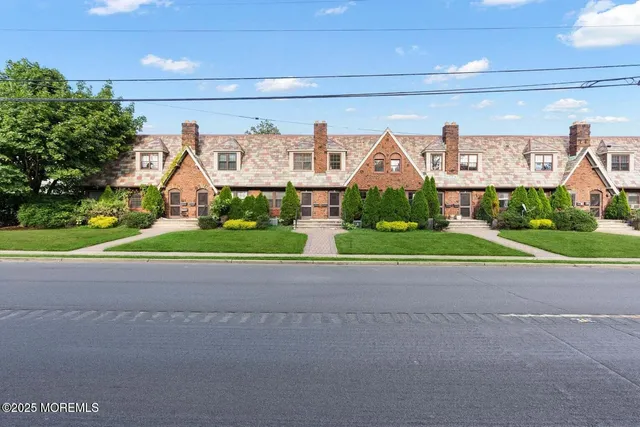 a view of a building with a yard and potted plants