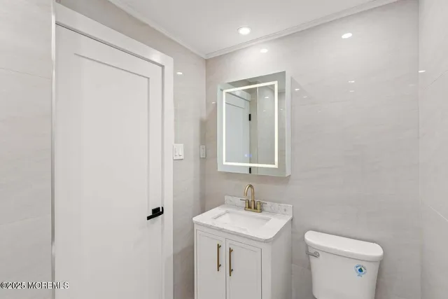 a white toilet sitting next to a bathroom sink