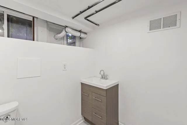 a view of an blue house with many windows