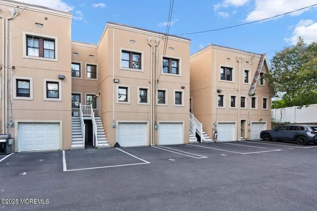 a view of a house with a yard and potted plants