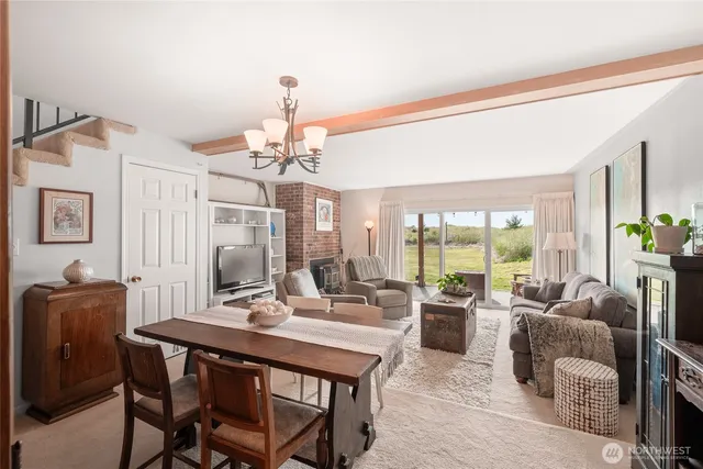 a living room with furniture a fireplace and a chandelier