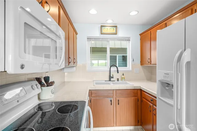 a utility room with sink dryer and washer