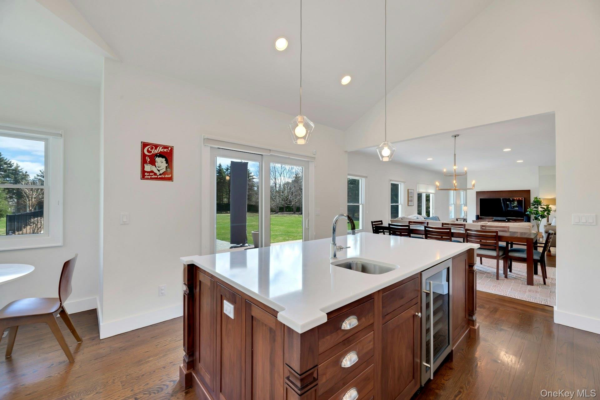 450 Sterling Woods Lane Southold, NY 11971 - Photo 12 of 41 a kitchen with kitchen island granite countertop a sink and refrigerator