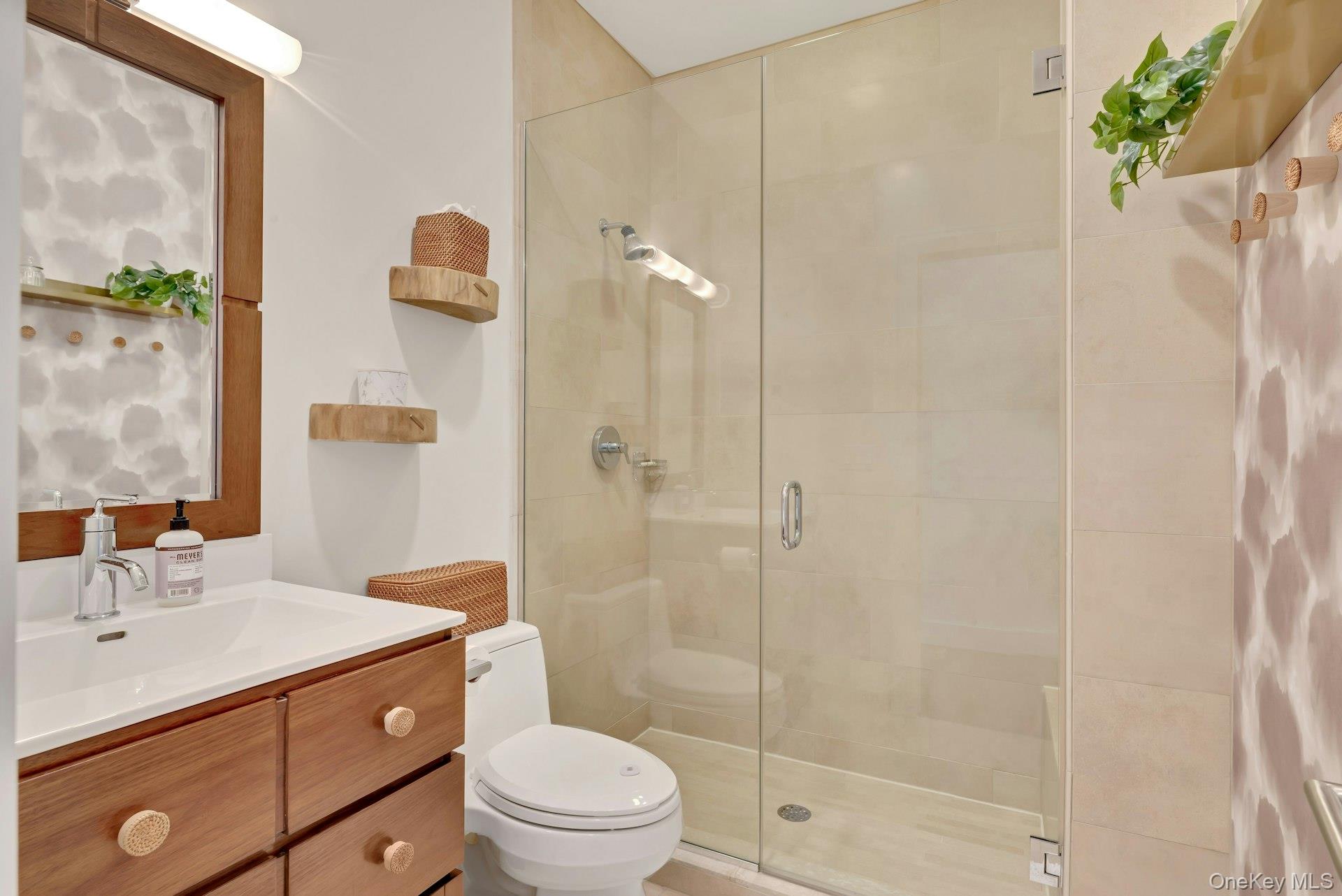 450 Sterling Woods Lane Southold, NY 11971 - Photo 14 of 41 a bathroom with a sink a toilet and shower