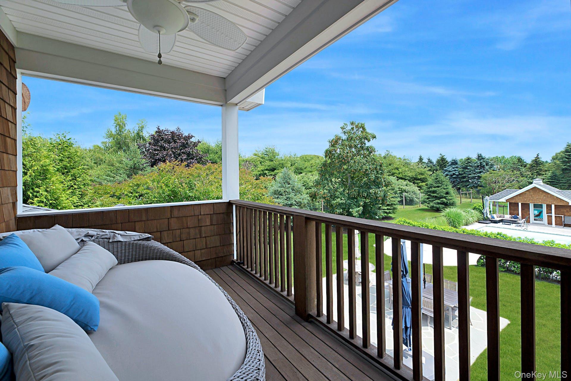 450 Sterling Woods Lane Southold, NY 11971 - Photo 19 of 41 a balcony with wooden floor and outdoor space
