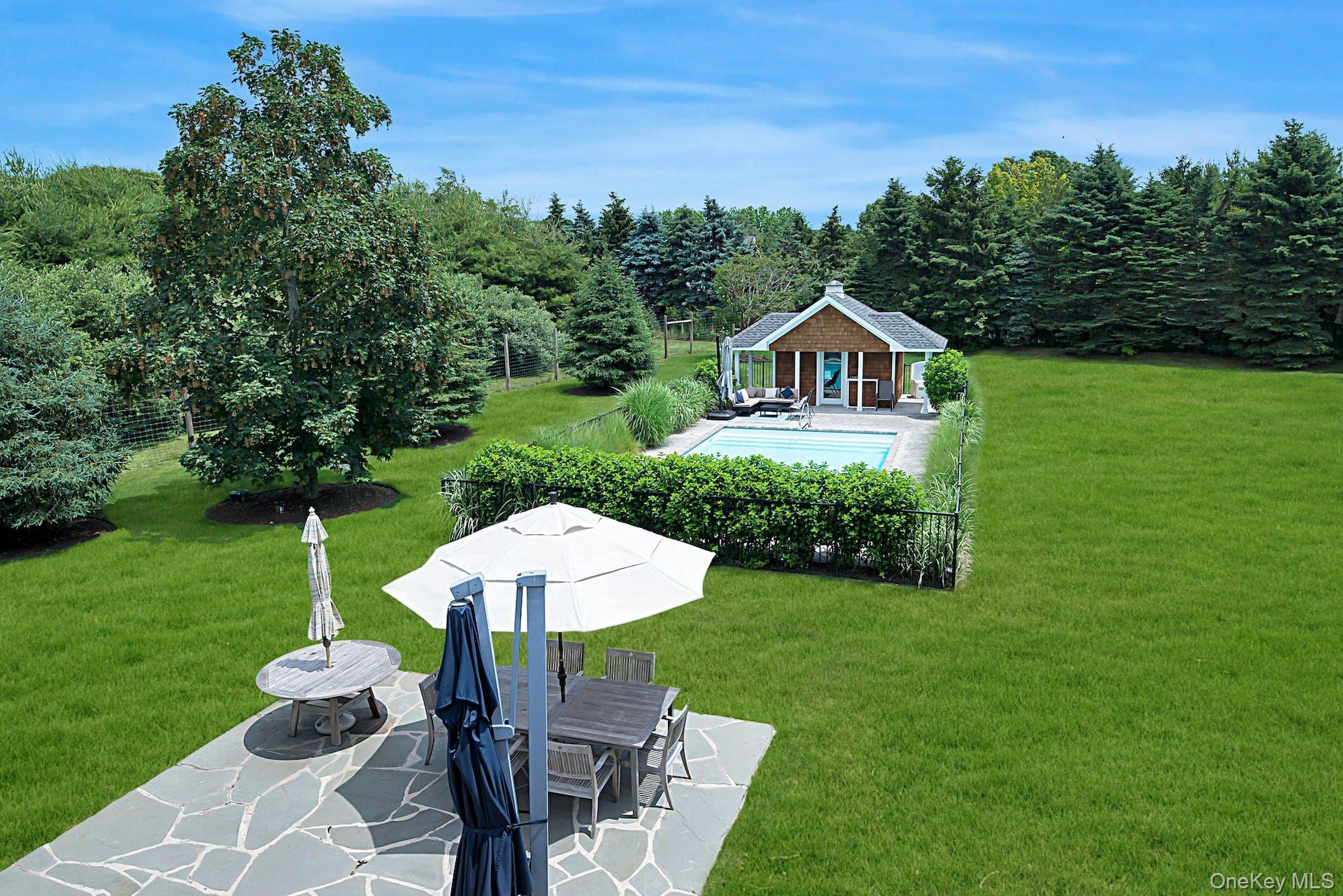 450 Sterling Woods Lane Southold, NY 11971 - Photo 20 of 41 a front view of a house with a yard and green space