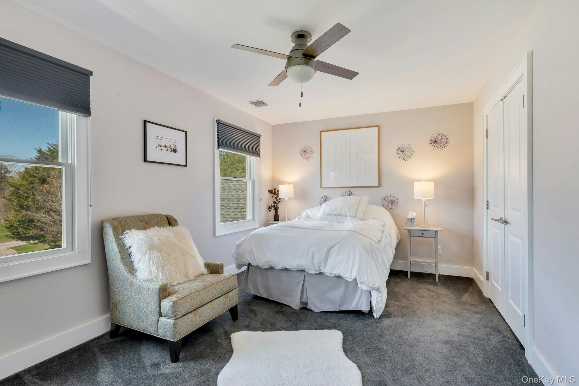 450 Sterling Woods Lane Southold, NY 11971 - Photo 21 of 41 a bed room with a bed and a couch