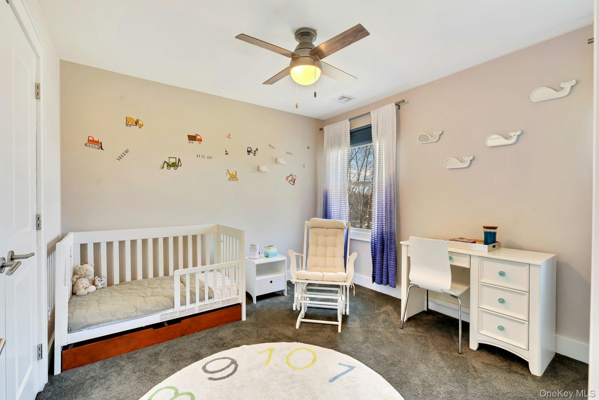 450 Sterling Woods Lane Southold, NY 11971 - Photo 23 of 41 a living room with furniture and a baby crib
