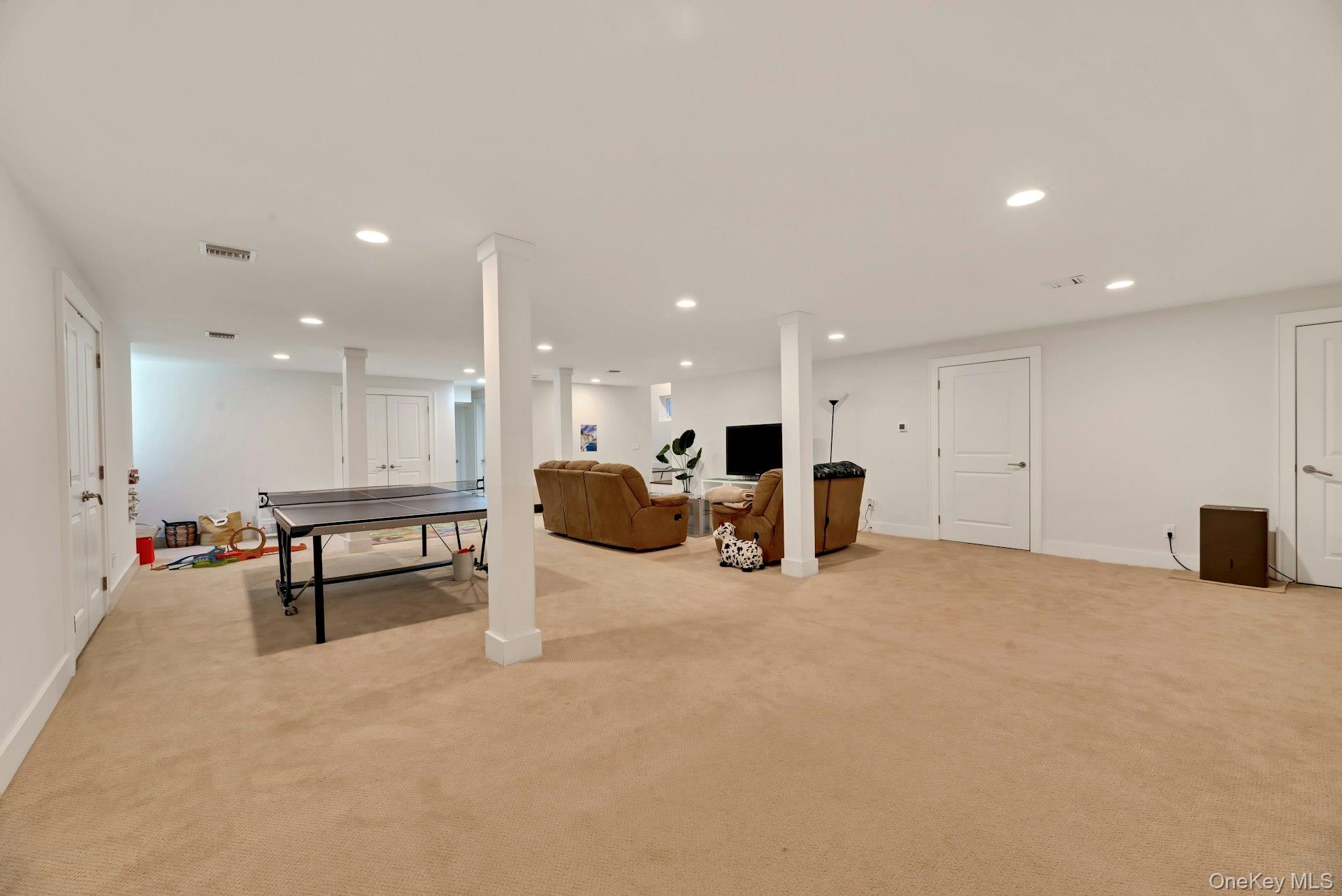 450 Sterling Woods Lane Southold, NY 11971 - Photo 27 of 41 a large room with furniture and a table
