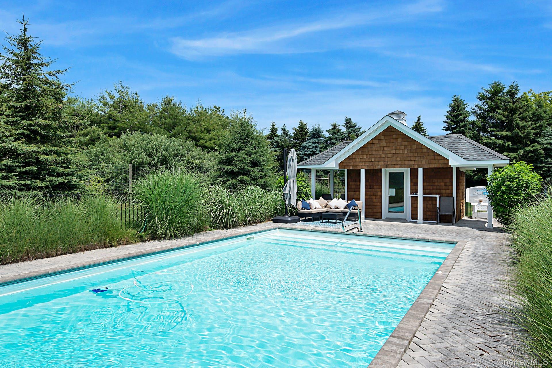 450 Sterling Woods Lane Southold, NY 11971 - Photo 30 of 41 a front view of a house with swimming pool having outdoor seating